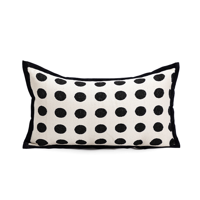 Polka dot pillow with black dots on a white background