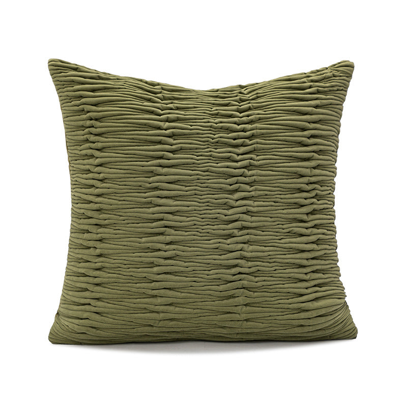 Textured green pillow on a white background