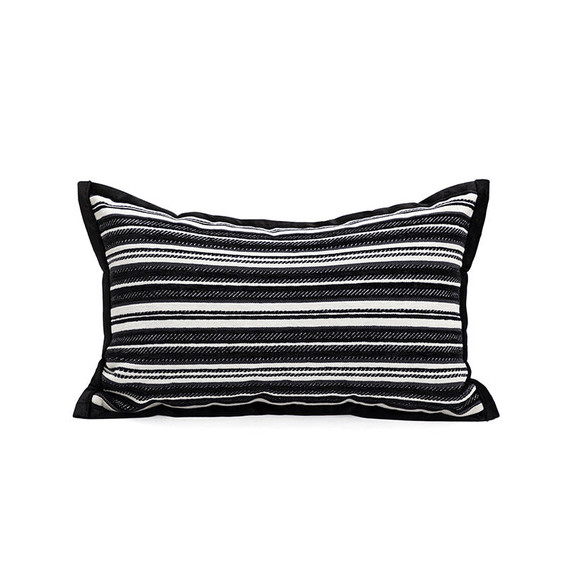 Black and white striped pillow on a white background