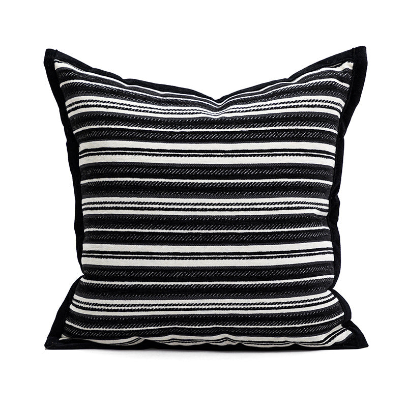 Black and white striped pillow on a white background