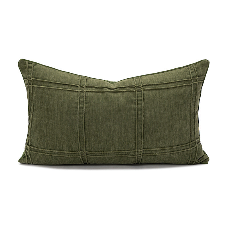 Green pillow with pleated texture on a white background
