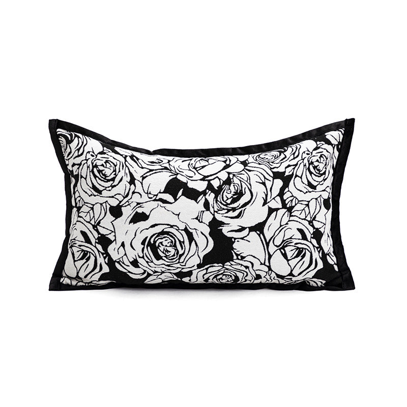 Decorative pillow with black and white rose pattern on a white background