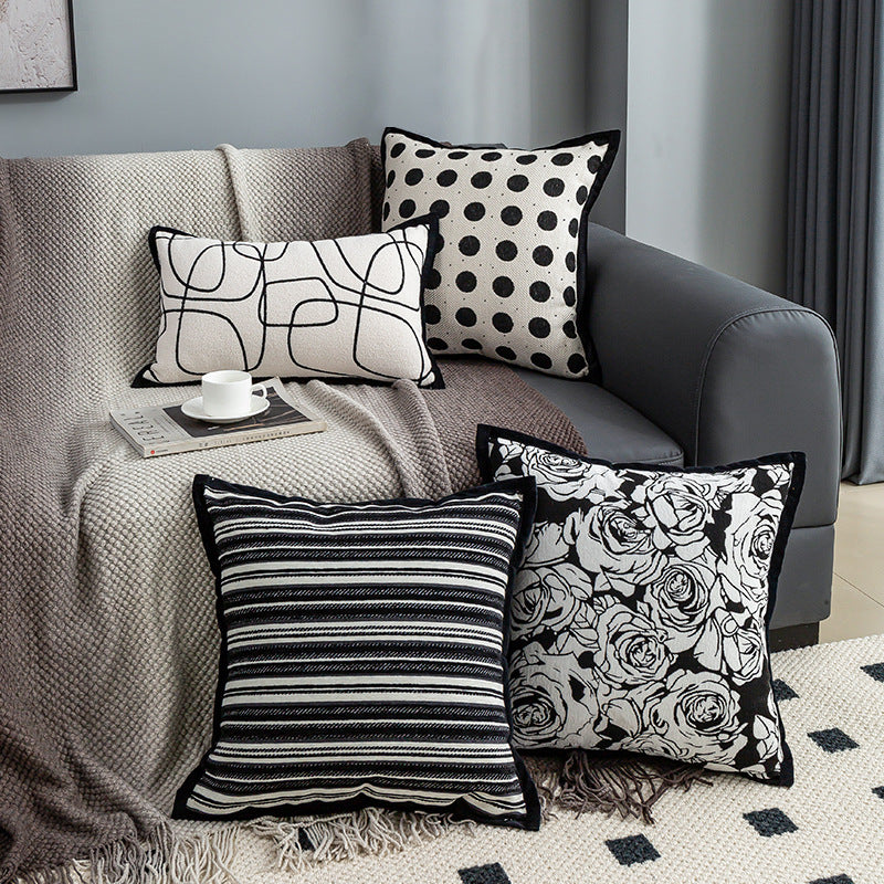 Decorative pillows with different patterns on a sofa in a living room setting.