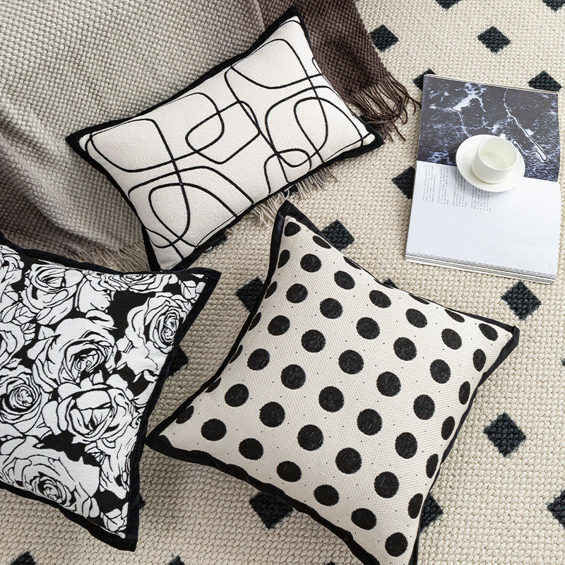 Three decorative pillows with different patterns on a textured surface.