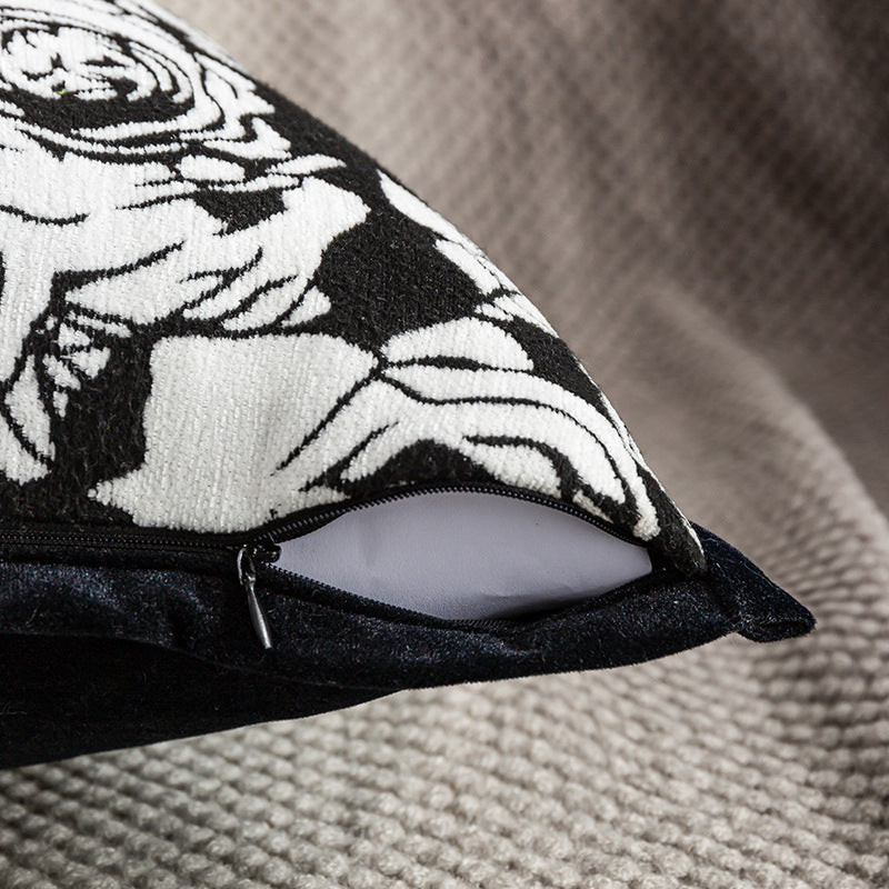 Decorative pillow with black and white design on a textured surface
